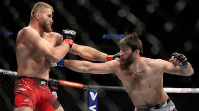 Magomed Ankalaev and Jan Blachowicz throw punches during their title fight at UFC 282. AP