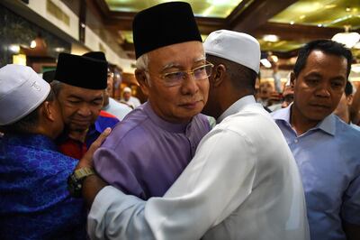 Malaysia's former prime minister Najib Razak, centre, and former deputy prime minister Ahmad Zahid Hamidi, second left, are greeted by supporters after Friday prayers at the Barisan Nasional party headquarters in Kuala Lumpur on May 18, 2018. Mohd Rasfan / AFP