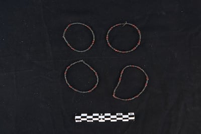 A set of four beaded bracelets made from small red and blue-green beads, found among burial goods in Aswan. Photo: Ministry of Tourism and Antiquities