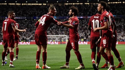 Liverpool's midfielder Jordan Henderson and Mohamed Salah celebrate after Divock Origi scored. AFP