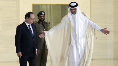 French President Francois Hollande arrives with Qatar's Emir Sheikh Tamim bin Hamad Al Thani to attend a signing ceremony for the sale of 24 Dassault Aviation-built Rafale fighter jet at the Diwan Palace in Doha. Reuters
