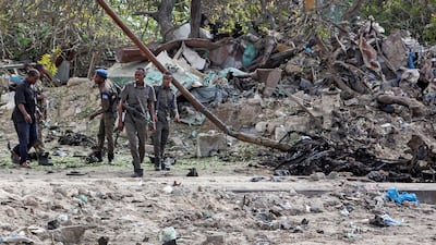 Somali soldiers attend the scene where a suicide car bomber detonated near the gates of the motor vehicle imports duty authority headquarters near the port in Mogadishu, Somalia. AP Photo