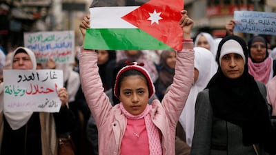 Demonstrators hold Jordanian national flag and chant slogans during a protest against a government's agreement to import natural gas from Israel, in Amman, Jordan. Reuters