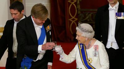 Queen Elizabeth II makes a toast with King Willem-Alexander of the Netherlands, during a state banquet at the Buckingham Palace in London. Yui Mok / Reuters