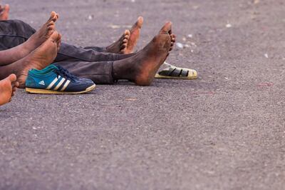 Migrants, who are part of a group intercepted aboard a dinghy off the coast, rest upon arriving at port in Arguineguin, in the Canary Island of Gran Canaria, Spain, October 16, 2017. Reuters