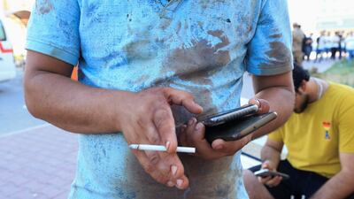 A man stands outside a hospital with a blood-stained shirt after the strike. Reuters