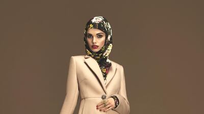 A nude ankle-length coat complements this floral maxi-dress and matching head covering