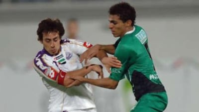 Al Ain's Jorge Valdivia holds of a Shabab tackler.