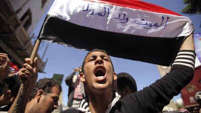An anti-Houthi protester shouts the slogan "Neither death nor humiliation" which is written on the Yemeni flag he is holding during a demonstration in the southwestern city of Taiz on February 9, 2015. Mohamed Al Sayaghi/Reuters