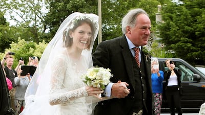 Rose Leslie is escorted by her father Sebastian as they arrive for her wedding at Rayne Church, Kirkton of Rayne in Aberdeenshire. Jane Barlow / PA via AP