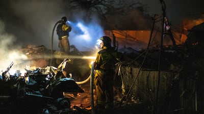 Firefighters work at destroyed houses following shelling in Donetsk. EPA