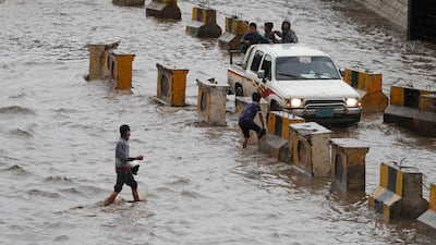 Yemeni children ride a vehicle through a flooded street following heavy rains in the old quarter of Sana'a, Yemen. EPA