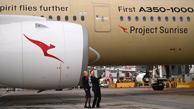 Qantas staff members take a selfie with an Airbus A350-1000ULR, developed for Qantas' long-haul Project Sunrise. EPA