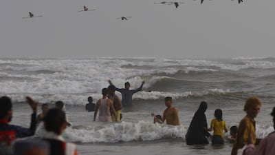 People gather at the beach to beat the hot weather during lockdown in Karachi, Pakistan. EPA