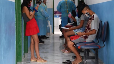 Brazilian indigenous people of the Marubo ethnic group wait to see doctors at a health post in Atalaia do Norte, Amazonas state, northern Brazil. The Brazilian Armed Forces are carrying out missions aimed to halt the Covid-19 spread in remote indigenous communities. AFP
