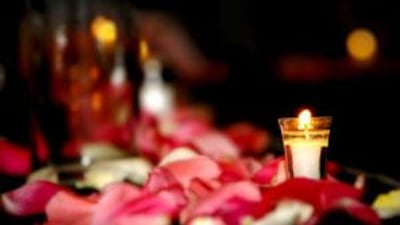 Tea lights and white candles in assorted sizes lend a romantic look to the room.