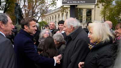 Emmanuel Macron meets residents prior to the ceremony. AP