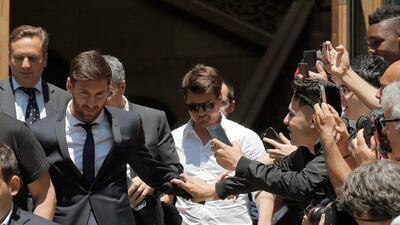 Lionel Messi, left, leaves the court in Barcelona on Thursday. Messi denied having knowledge of the tax issues that led to fraud charges against him. Manu Fernandez / AP Photo