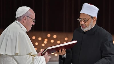 The religious leaders exchange documents. AFP