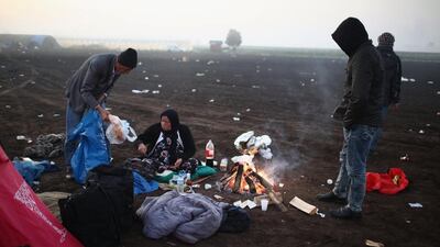 Migrants huddle around a campfire on a cold morning at the Hungarian border with Serbia. The number of people leaving their homes in wartorn countries such as Syria marks the largest migration of people since World War II.