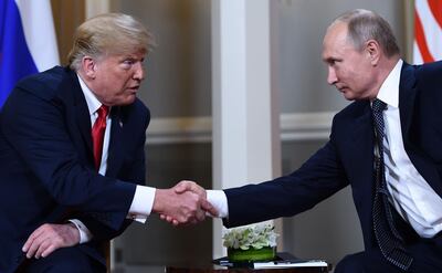 Body-language watchers said Mr Trump and Mr Putin resembled prize fighters as they met. Brendan Smialowski / AFP