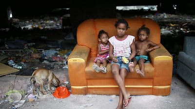 Children look at the camera in an impoverished area in the unpacified Complexo da Mare slum complex, one of the largest ‘favela’ complexes in Rio. (Mario Tama/ / Getty Images / March 30, 2014)