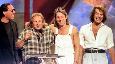 Members of the band Van Halen, from left, Alex Van Halen, Michael Anthony, Eddie Van Halen are reunited with former lead singer David Lee Roth, right, on stage at the 1996 MTV Video Music Awards in New York on September 4. Photo by Jeff Christensen