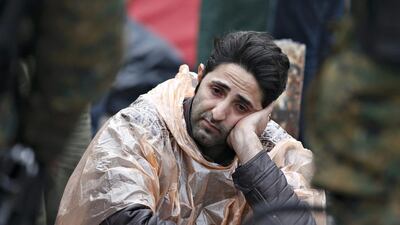 A migrant waits to cross the border from Greece into Macedonia. Stoyan Nenov / Reuters