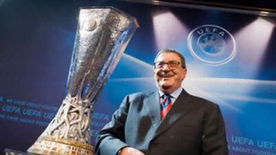 The former Turkey footballer and ambassador to this season's final in Istanbul, Can Bartu, poses with the Uefa Cup after the draw for the group phase.