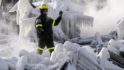 A police investigator signals to colleagues as they search through icy rubble trying to locate victims of a fire that destroyed a seniors’ residence January 24, 2014, in L’Isle-Verte, Que. Five people are confirmed dead and 30 people are still missing. The cause of Thursday morning’s blaze is unclear police said. Authorities are using steam to melt the ice and to preserve any bodies that are buried. Ryan Remiorz / AP photo/The Canadian Press
