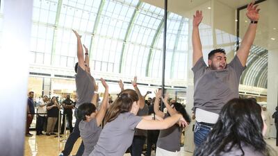 Apple employees cheer and celebrate as the new Apple Store opens at Mall of the Emirates. Sarah Dea / The National