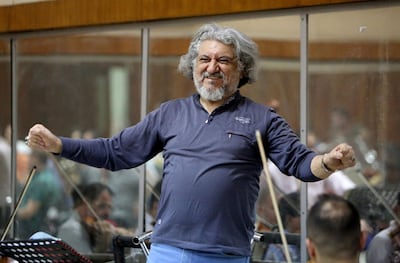 Iraqi National Symphony Orchestra conductor Mohammed Amin Ezzat leads musicians during a rehearsal AFP
