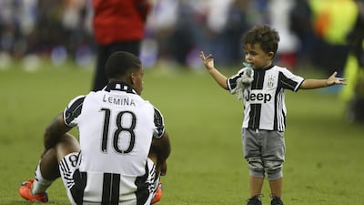What went wrong dad? Juventus midfielder Mario Lemina sits next to his son after his club’s Champions League defeat to Real Madrid in Cardiff. Dave Thompson / AP Photo