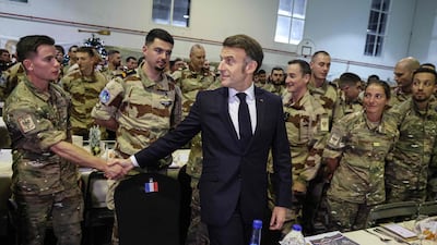 French President Emmanuel Macron at Christmas dinner with troops of the 5th Cuirassier Regiment's base in Zayed Military City, Abu Dhabi. AFP