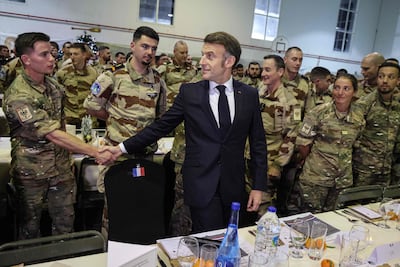 French President Emmanuel Macron at a Christmas dinner with troops of the 5th Cuirassier Regiment's base in Zayed Military City, Abu Dhabi, on December 21, 2025. AFP