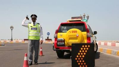 A Road Service Patrol officer shows how he can help to prevent further accidents at a crash site.