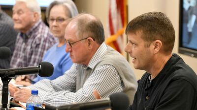 McMinn County School Board member Mike Cochran, far right, details his meeting with a rabbi recently, Thursday, Feb. 10, 2022, in Athens, Tenn. The board heard from concerned citizens about the removal of the Pulitzer Prize-winning graphic novel about the Holocaust "Maus," from the district's curriculum at the meeting. Board member, Mike Cochran, recounted a conversation with a Jewish rabbi who had suggested to him that a Holocaust survivor could talk to students as a possible replacement for the removed book. (Robin Rudd / Chattanooga Times Free Press via AP)