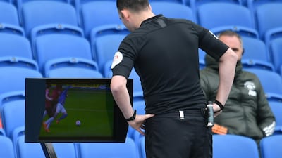 Referee Chris Kavanagh looks at a monitor of a replay of an incident involving Brighton's Aaron Connolly and Manchester United's Paul Pogba. Reuters