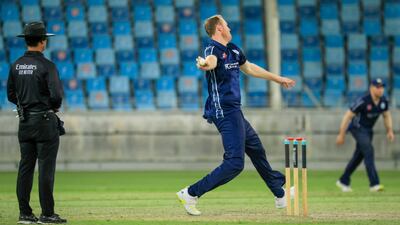 Adrian Neill bowls for Scotland against Oman. Photo: ICC