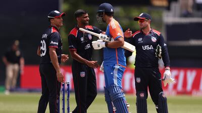 Players shake hands at the end of the match after India has secured victory with 10 balls remaining. AFP