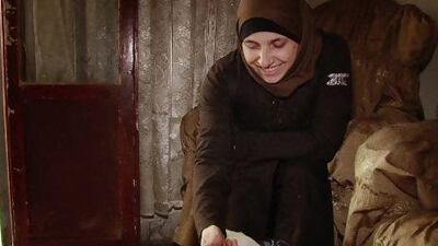 Umm Moawiya, a hairdresser turned volunteer field nurse, caresses Hibat Allah after adopting the newborn baby found in a street in the Bustan Al Qasr district of Aleppo.