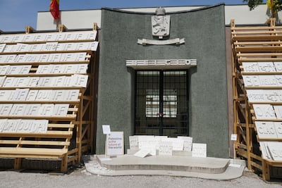 Posters and signs in support of Palestine on the door of the closed Belgian pavilion. EPA