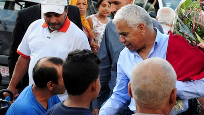 Safi Saïd, a candidate for the upcoming presidential elections, right, greets supporters during an electoral meeting in Ettadhamen City near Tunis, Tunisia. AP