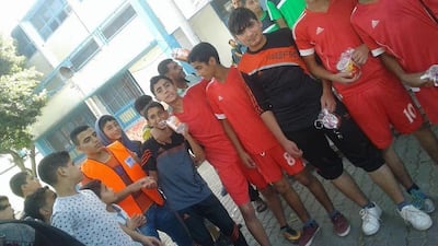 From left, Ibrahim, in orange vest, with Murad and Saber. Photo: Supplied