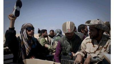 Sneakers are handed out to Libyan rebels on a checkpoint on the frontline near the outskirts of Ajdabiya, south of Benghazi.
