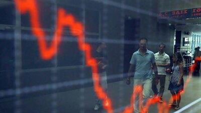 The US credit rating downgrade and sovereign debt crisis hounding European countries may affect emerging Asian economies. Above, an outdoor display of the Greek stock index.