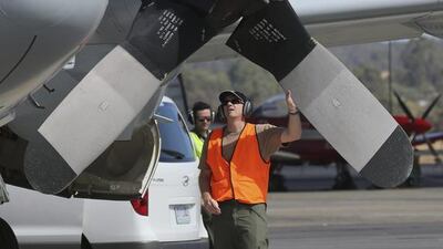 A ground crewman carries out a pre-flight check on a Royal Australian Air Force AP-3C Orion prior to its takes off at RAAF Pearce Base to join the search for the missing Malaysia Airlines flight MH370 in Perth, Australia. Rob Griffith / AP