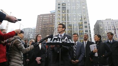 Washington Attorney General Bob Ferguson, center, talks to reporters Friday, Feb. 3, 2017, following a hearing in federal court in Seattle. A U.S. judge on Friday temporarily blocked President Donald Trump's ban on people from seven predominantly Muslim countries from entering the United States after Washington state and Minnesota urged a nationwide hold on the executive order that has launched legal battles across the country.(AP Photo/Ted S. Warren)