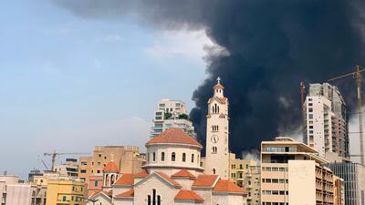 Thick black columns of smoke rise into the sky, in Beirut. AFP