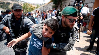 Israeli border guards detain a Palestinian youth during a demonstration outside the Lions Gate entrance to Al Aqsa mosque compound in Jerusalem's Old City on July 17, 2017. Ahmad Gharabli / AFP